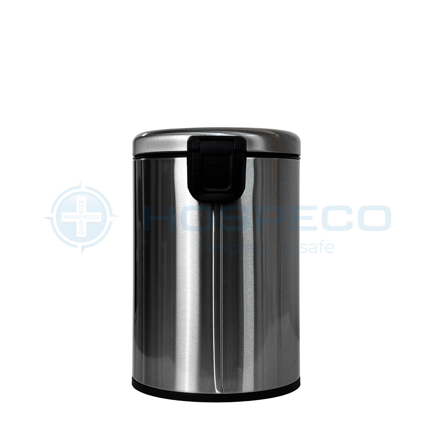Close-up of a stainless steel cylindrical trash can with a black lid latch.